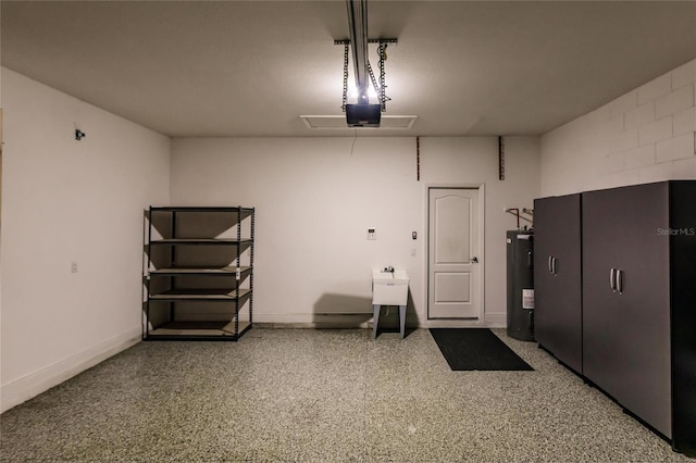 garage with a garage door opener, sink, and water heater