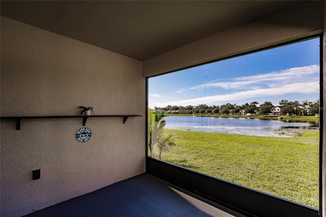 unfurnished sunroom with a water view