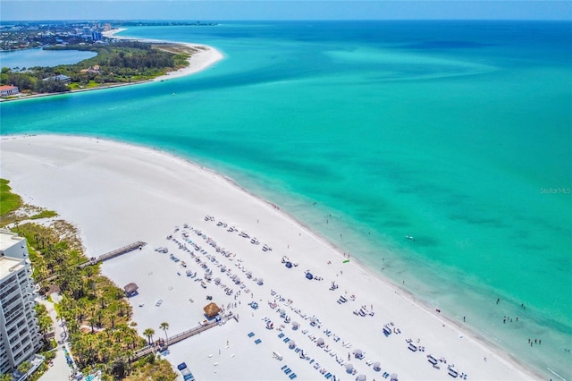 drone / aerial view featuring a water view and a beach view