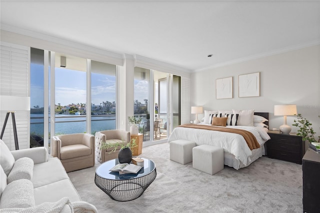 carpeted bedroom with access to exterior, a wall of windows, crown molding, and a water view