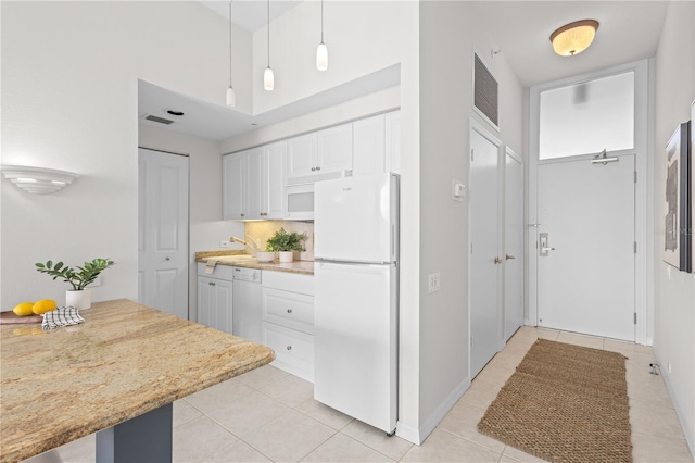 kitchen with white cabinetry, sink, pendant lighting, white appliances, and light tile patterned floors