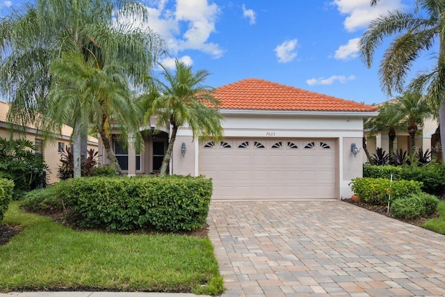 mediterranean / spanish-style home with a garage