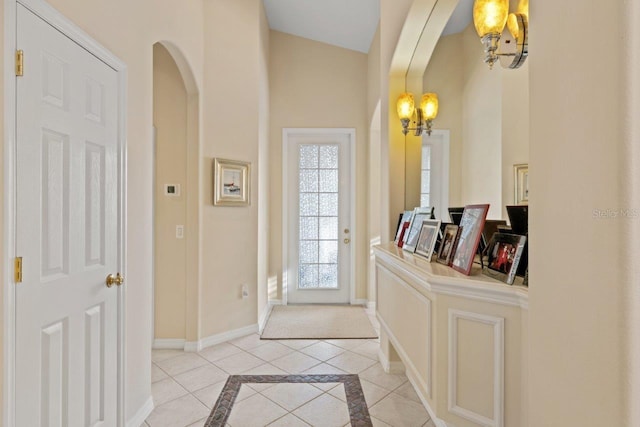 tiled entryway featuring vaulted ceiling and plenty of natural light