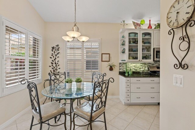 dining room with a notable chandelier and light tile patterned floors