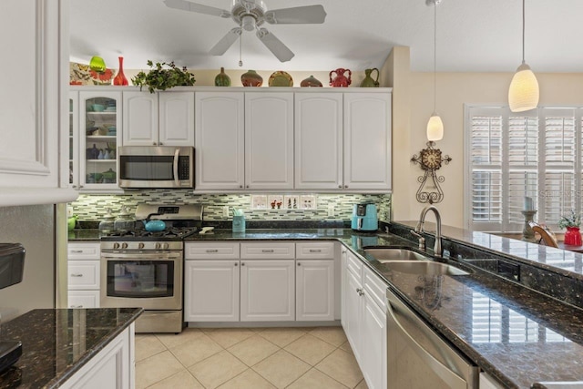 kitchen featuring ceiling fan, sink, stainless steel appliances, and white cabinets