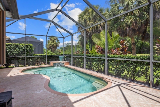 view of swimming pool with a patio, pool water feature, and a lanai