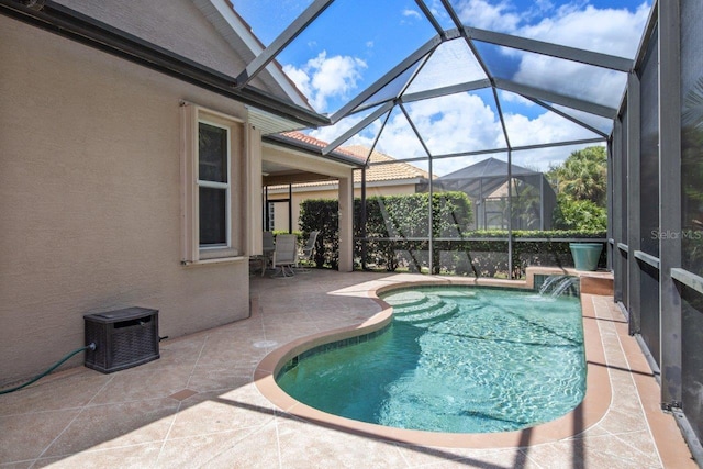 view of pool featuring a patio, pool water feature, and a lanai