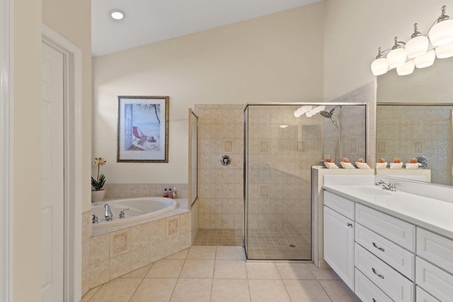 bathroom with lofted ceiling, shower with separate bathtub, vanity, and tile patterned floors