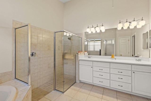 bathroom featuring plus walk in shower, vanity, and tile patterned floors