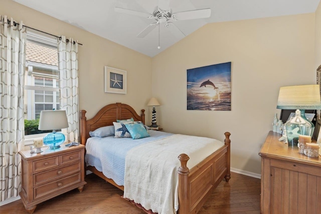 bedroom with ceiling fan, vaulted ceiling, and dark wood-type flooring