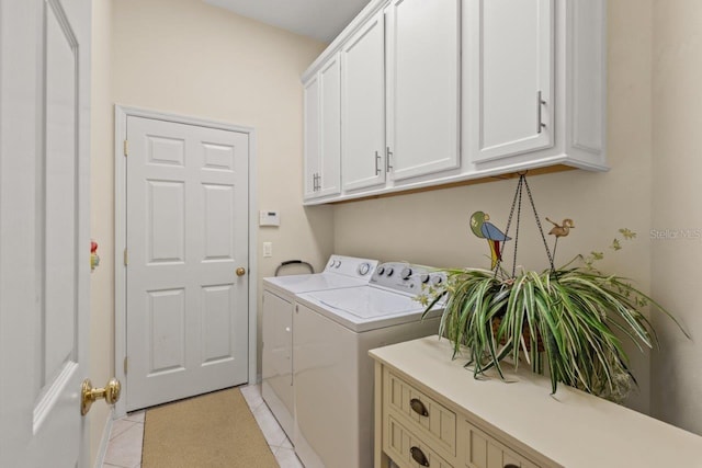 washroom featuring light tile patterned floors, independent washer and dryer, and cabinets