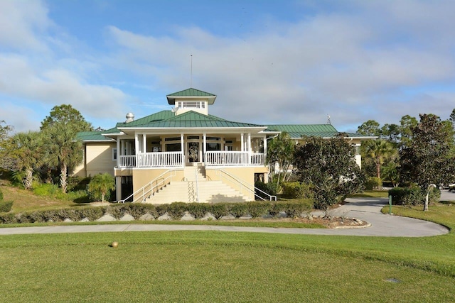 exterior space featuring a porch and a front yard