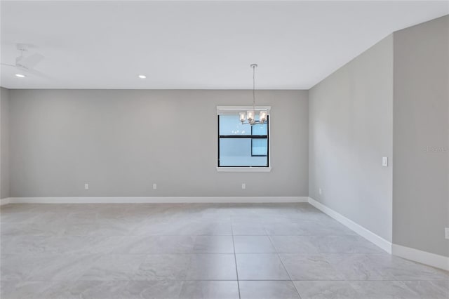 spare room with ceiling fan with notable chandelier