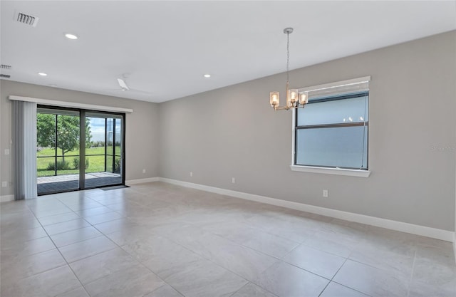 empty room featuring a notable chandelier