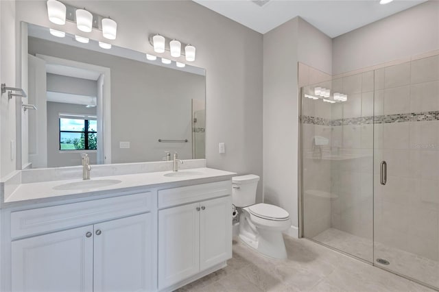 bathroom featuring vanity, toilet, and a shower with shower door