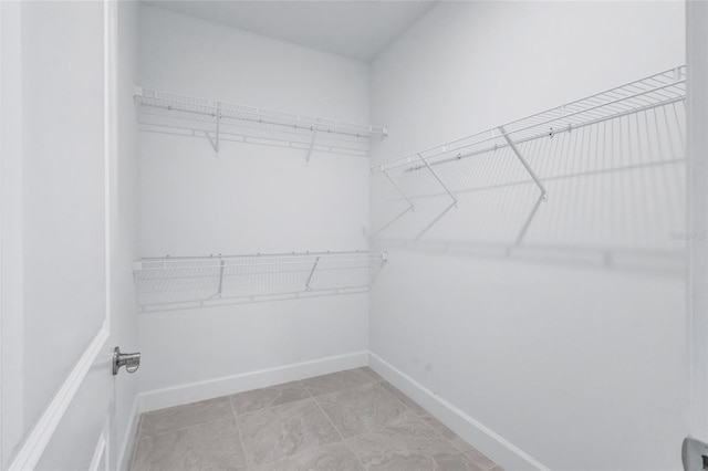 walk in closet featuring light tile patterned floors