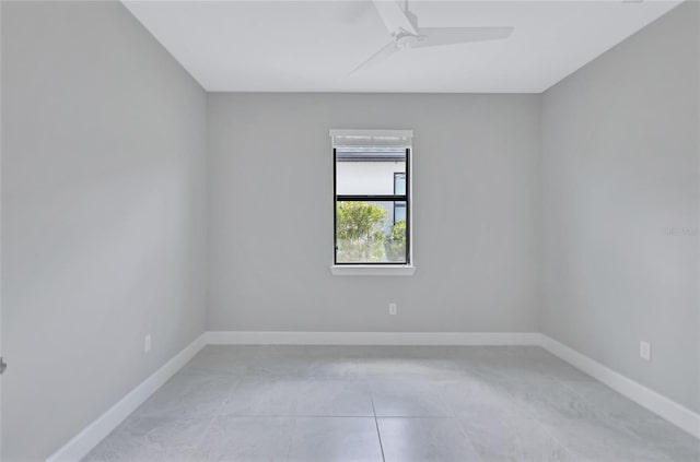 tiled empty room with ceiling fan