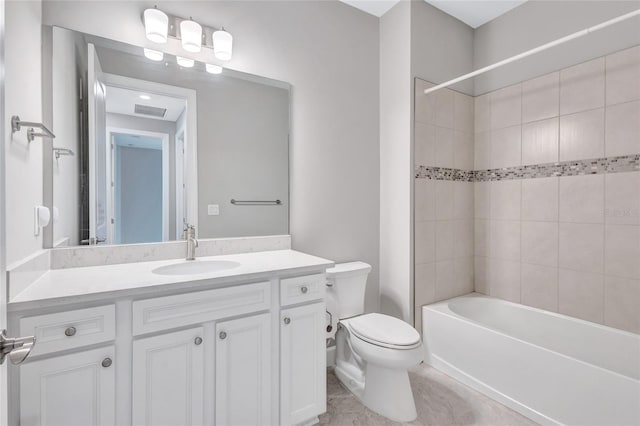 full bathroom with tiled shower / bath combo, vanity, and toilet