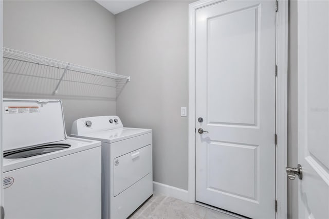 clothes washing area featuring separate washer and dryer