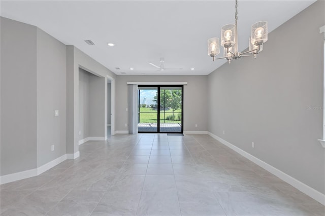 empty room featuring a chandelier