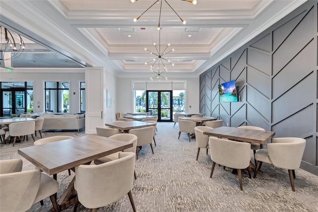 carpeted dining area with plenty of natural light, crown molding, a notable chandelier, and french doors