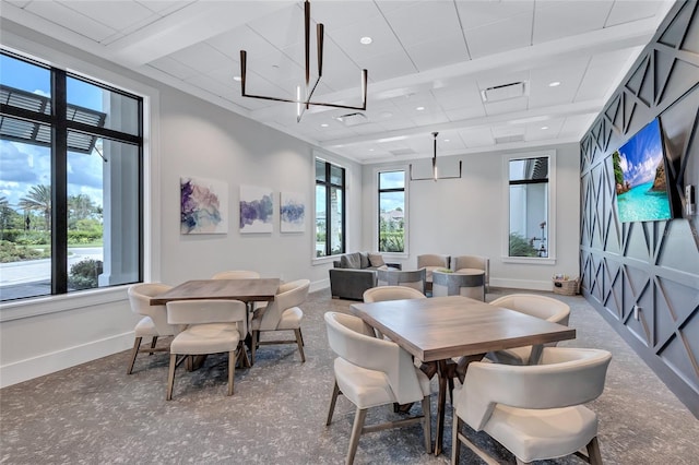 dining area featuring carpet and an inviting chandelier