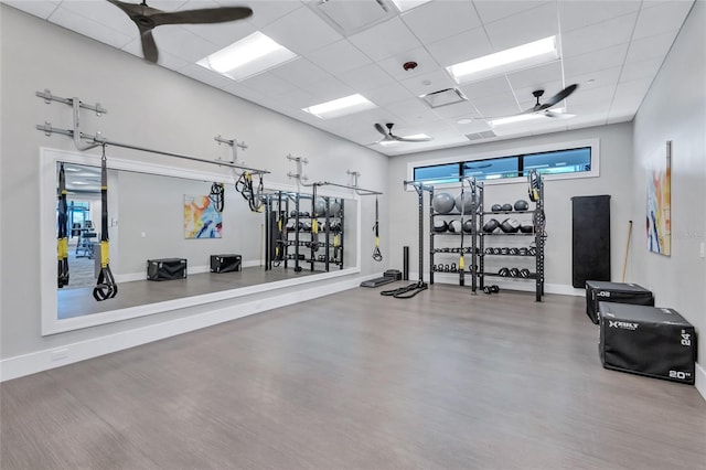 gym featuring ceiling fan and a drop ceiling