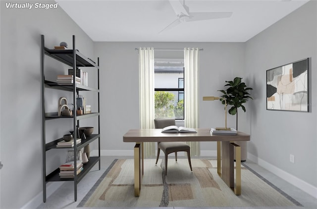 office area featuring light carpet and ceiling fan