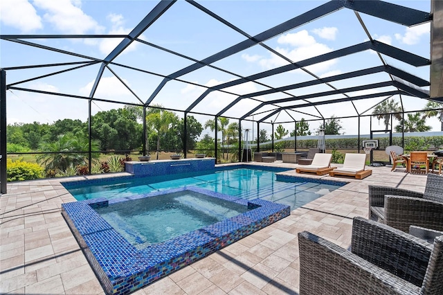 view of pool with glass enclosure, a patio, and an in ground hot tub