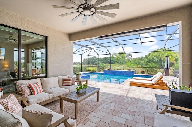 view of pool with a patio area, glass enclosure, outdoor lounge area, ceiling fan, and an in ground hot tub