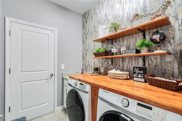 washroom with separate washer and dryer and light tile patterned flooring