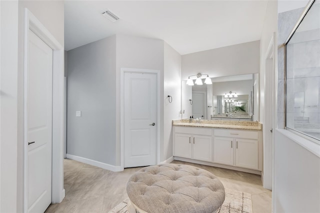 bathroom with tile patterned floors and vanity