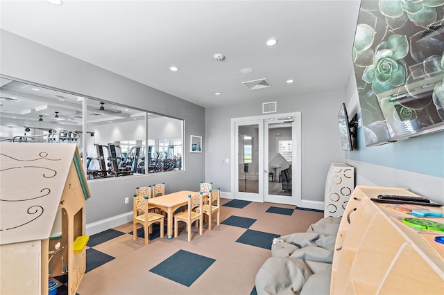 recreation room with carpet flooring and french doors