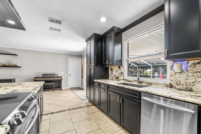 kitchen featuring sink, crown molding, a textured ceiling, light tile patterned floors, and stainless steel appliances