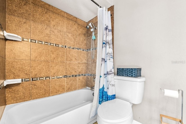 bathroom featuring shower / bathtub combination with curtain and toilet