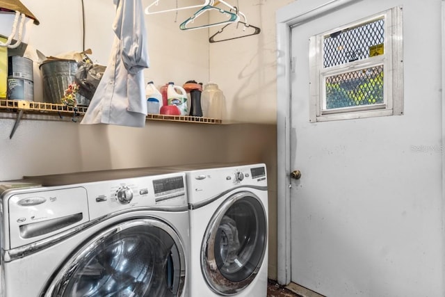 clothes washing area with washing machine and dryer