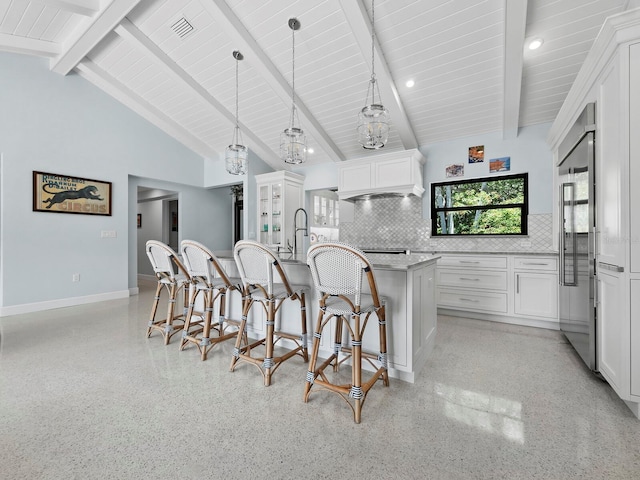 1400 Quail Dr, Sarasota, FL 34231 - kitchen featuring light speckled floor, pendant lighting, white cabinets, and a center island with sink