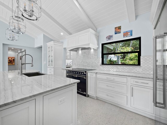 kitchen featuring backsplash, electric range oven, sink, white cabinetry, and vaulted ceiling with beams