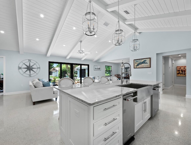 kitchen with pendant lighting, a kitchen island with sink, ceiling fan, light stone counters, and white cabinets