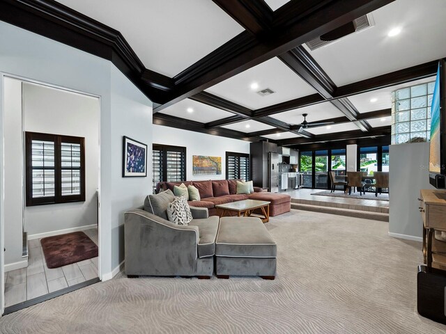 living room with coffered ceiling, ceiling fan, carpet, and beamed ceiling