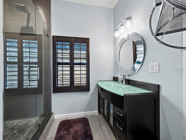 1400 Quail Dr, Sarasota, FL 34231 - full bathroom featuring a stall shower, wood tiled floor, baseboards, and vanity