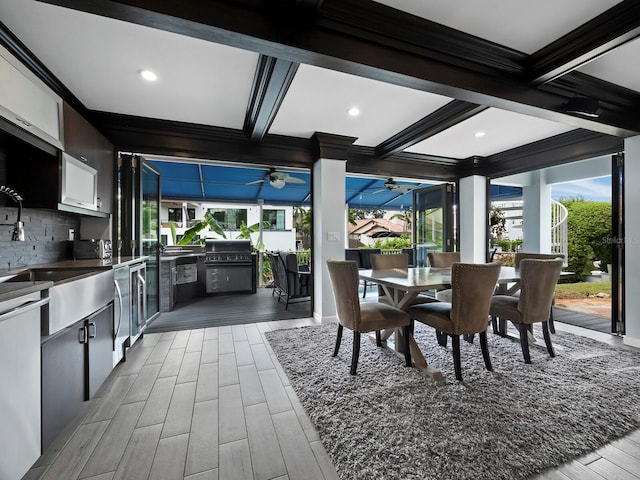 dining room with coffered ceiling, ceiling fan, hardwood / wood-style floors, and crown molding