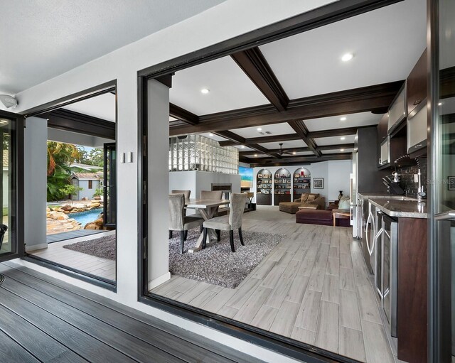 interior space with coffered ceiling, hardwood / wood-style flooring, and indoor bar