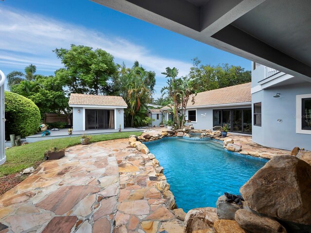 view of pool with an outdoor structure and a patio