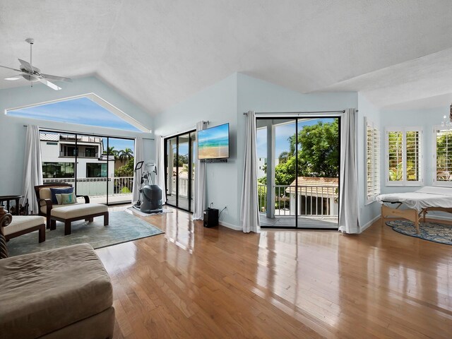 1400 Quail Dr, Sarasota, FL 34231 - living area featuring lofted ceiling, light wood finished floors, a wealth of natural light, and baseboards