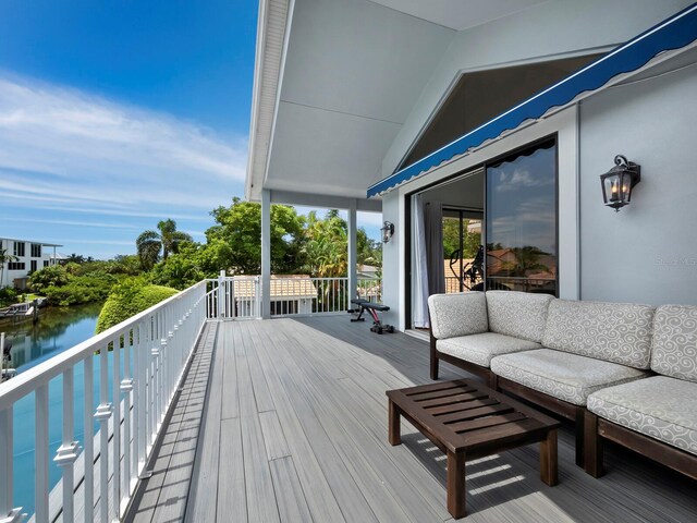 deck featuring outdoor lounge area and a water view