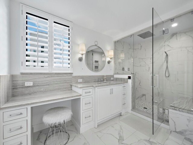 bathroom featuring vanity, an enclosed shower, backsplash, tile patterned flooring, and tile walls