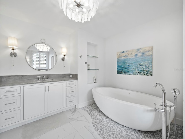 1400 Quail Dr, Sarasota, FL 34231 - bathroom with a freestanding tub, vanity, marble finish floor, and an inviting chandelier