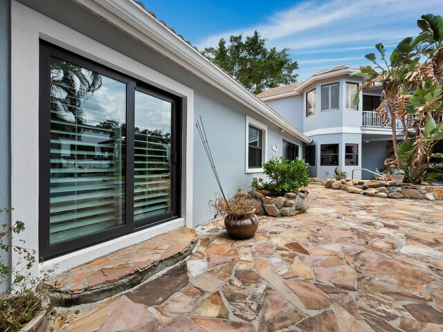 exterior space featuring a balcony and a patio