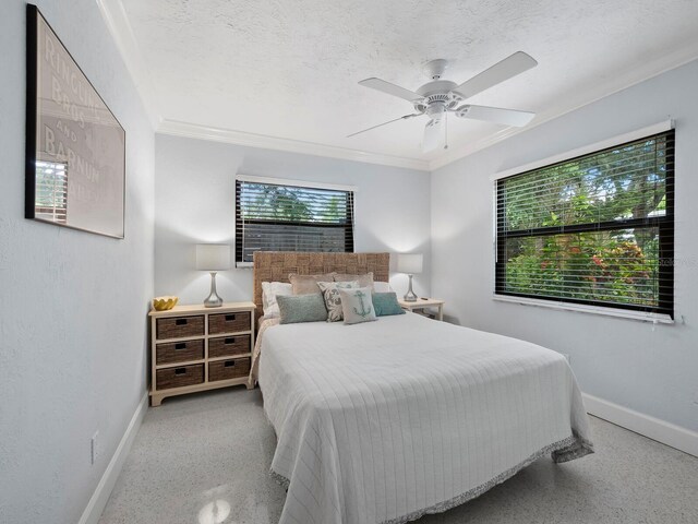 bedroom with a textured ceiling, ceiling fan, and ornamental molding